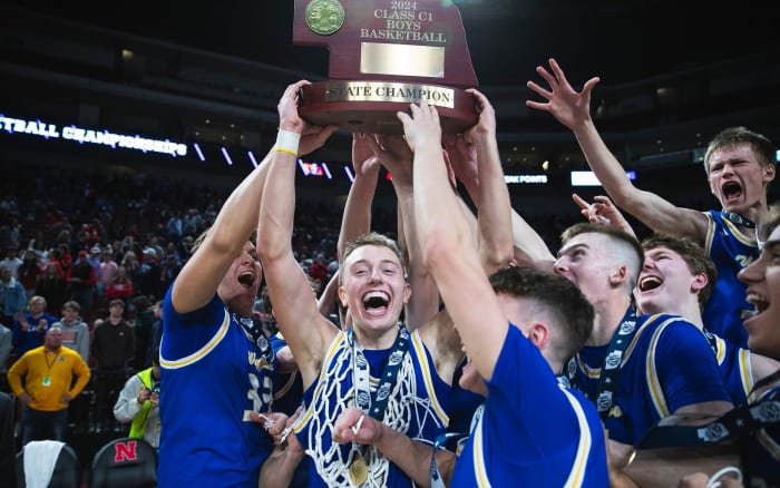Marcus Glock, center, and his Wahoo teammates raise the trophy in celebration moments after defeating Auburn for the Class C-1 state title on Saturday in Lincoln. Photo by @wahoopublic on X.